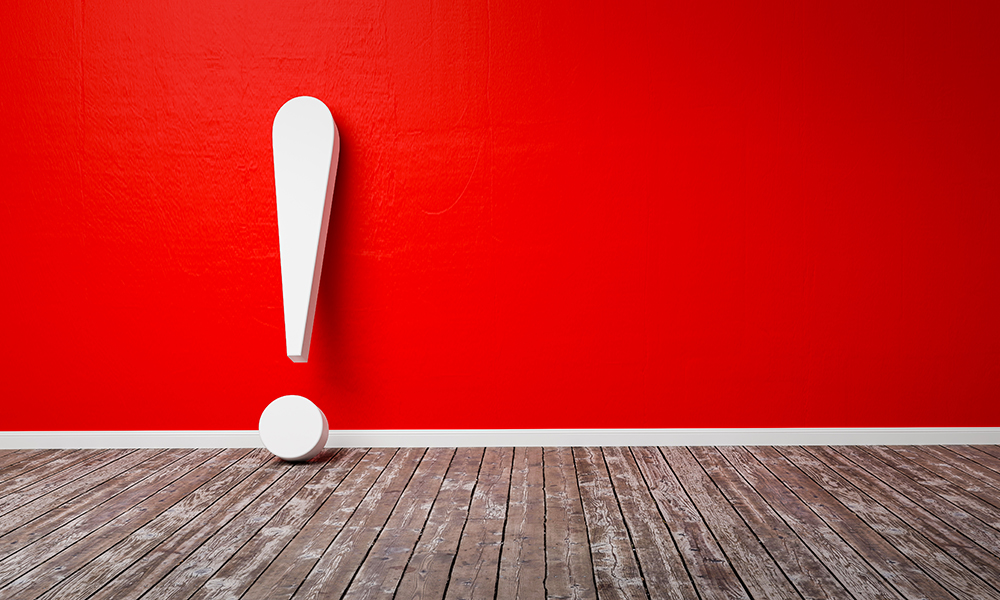 White exclamation mark on red wall
